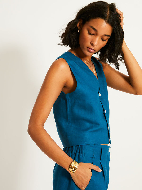 Close up on a Woman Standing Wearing lemlem ADOWA | Shell Tank  featuring a rich mid-blue green color and matching shorts
