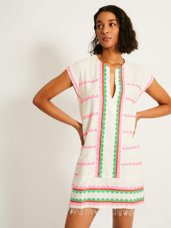 Woman Standing Wearing lemlem ELINA Caftan featuring a playful, preppy scalloped Tibeb weave with vibrant green, soft pink, and fiery red accents