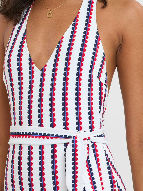 Woman Standing wearing lemlem LIDYA One Piece featuring a playful, preppy scalloped Tibeb weave with classic navy, red, and vibrant blue accents.