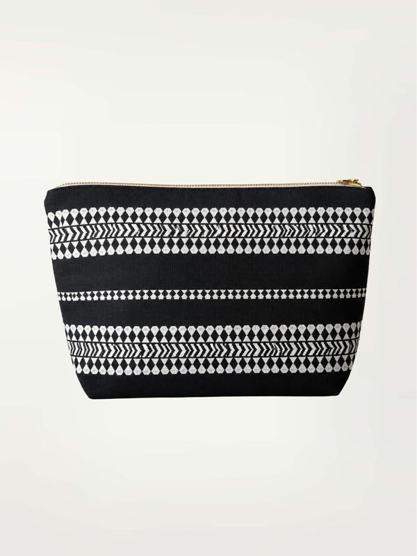 Product front shot of CORA Pouch featuring white tibeb pattern on a black background