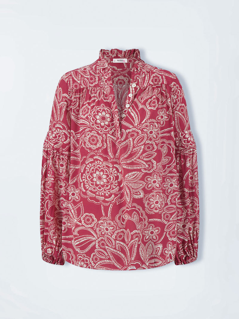 Product shot of  lemlem MITA Blouse featuring rich ruby-red fabric  adorned with intricate white floral and leaf motifs print