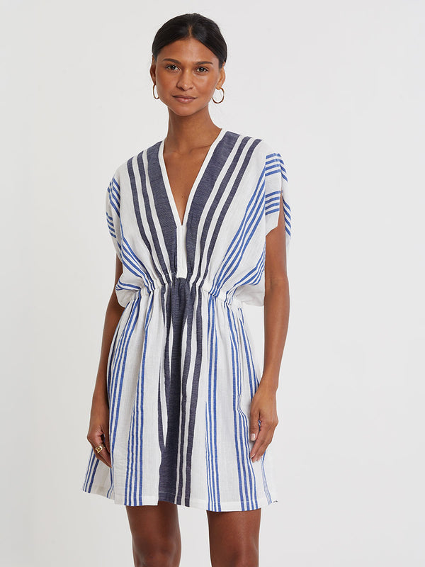 Woman wearing lemlem handwoven ALEM Dress featuring bold two-tone stripes in classic navy, blue colors on crispy white background.