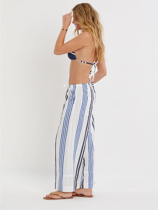 Woman wearing lemlem handwoven DESTA Pants  featuring bold two-tone stripes in classic navy, blue colors on crispy white background.