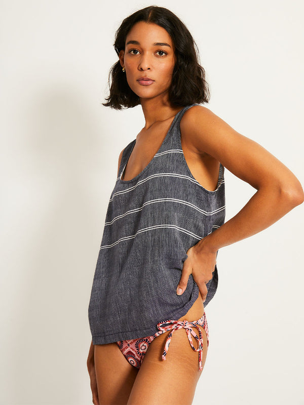 Woman Standing Wearing lemlem  KATI Top featuring chambray navy color accented with fine, textured white stripes
