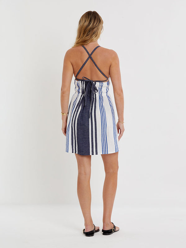 Woman wearing lemlem handwoven KAYLA Dress featuring bold two-tone stripes in classic navy, blue colors on crispy white background.