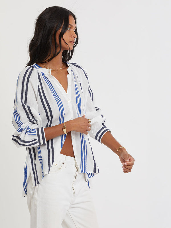 Woman wearing lemlem handwoven MITA Blouse featuring bold two-tone stripes in classic navy, blue colors on crispy white background.