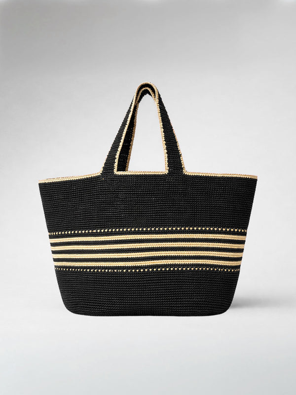 lemlem Black hand-crocheted raffia tote bag with gold stripes on a white background
