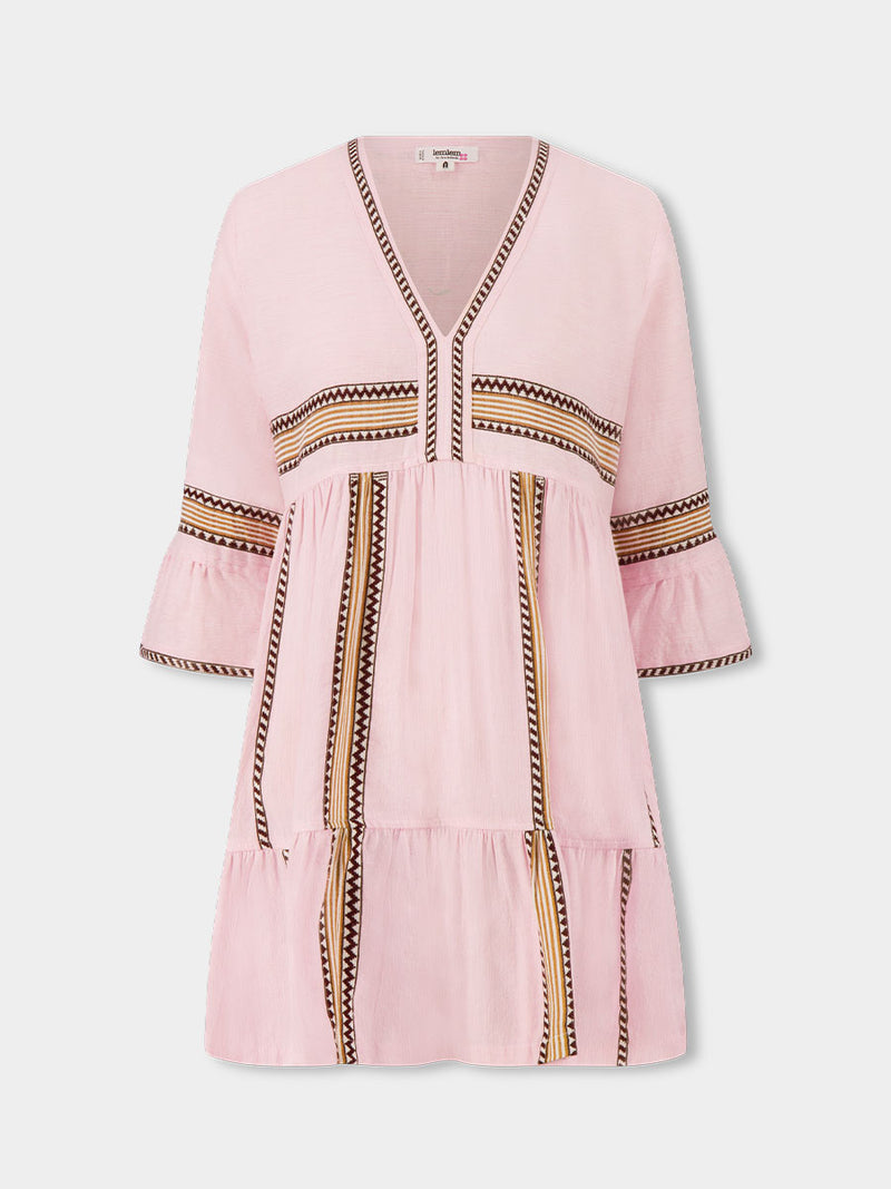 Product front shot of  lemlem HANNA Flutter Dress featuring detailed bands of deep burgundy, bronze, and pink stripes beautifully placed on a light cream 