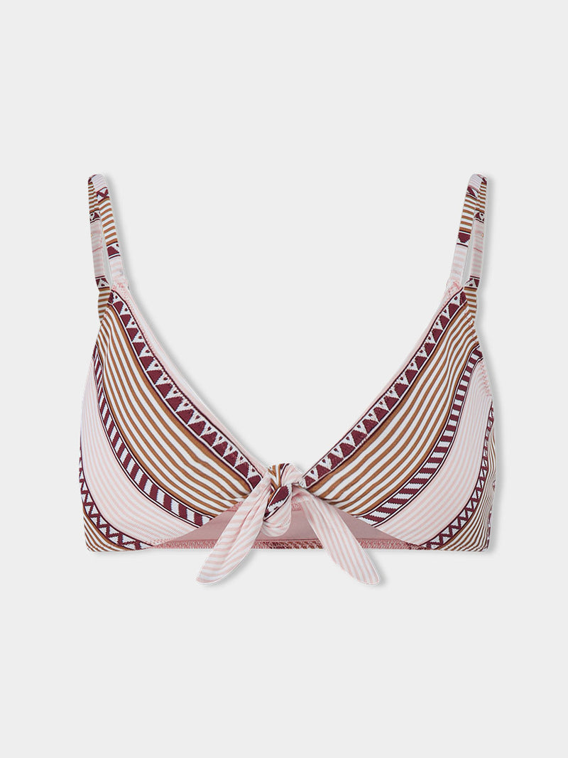 Product front shot of  lemlem SARA Tie Front Top featuring detailed bands of deep burgundy, bronze, and pink stripes beautifully placed on a light cream 
