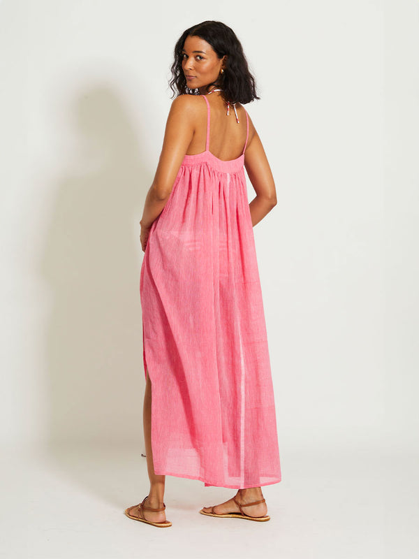 Back of a Woman Standing Wearing lemlem EDA | Slip Dress featuring sheer fabric in pink watermelon color