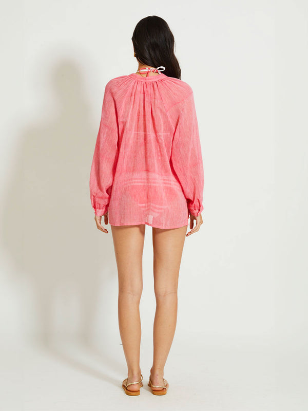 Back of a Woman Standing Wearing lemlem MITA | Button Up Blouse featuring sheer fabric in pink watermelon color