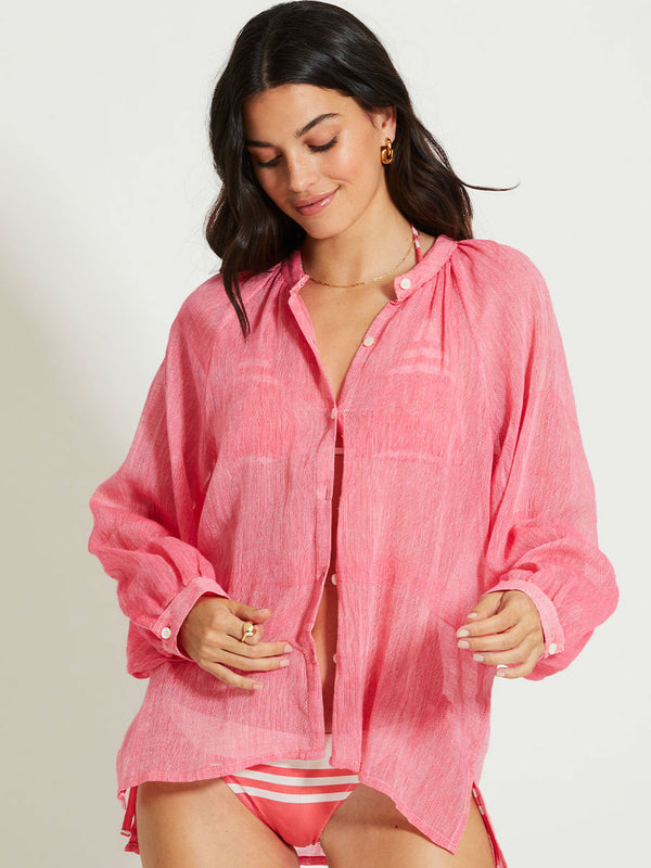 Woman Standing Wearing lemlem MITA | Button Up Blouse featuring sheer fabric in pink watermelon color