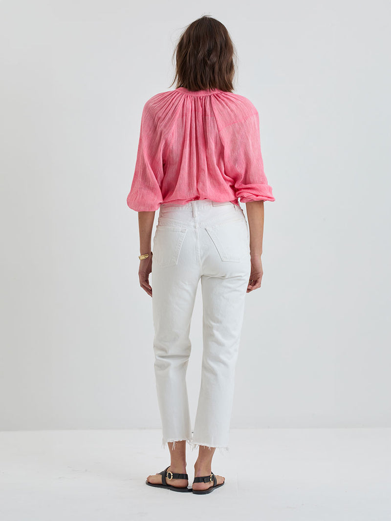 Back of a Woman Standing Wearing lemlem MITA | Button Up Blouse featuring sheer fabric in pink watermelon color