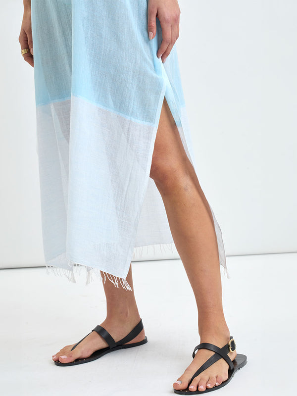 Close up on woman's legs standing wearing DALILA Caftan featuring light blue, aqua, mint, soft green and cream