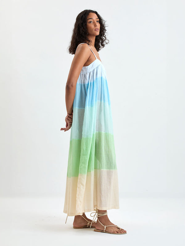 Woman standing wearing EDA Dress featuring light blue, aqua, mint, soft green and cream
