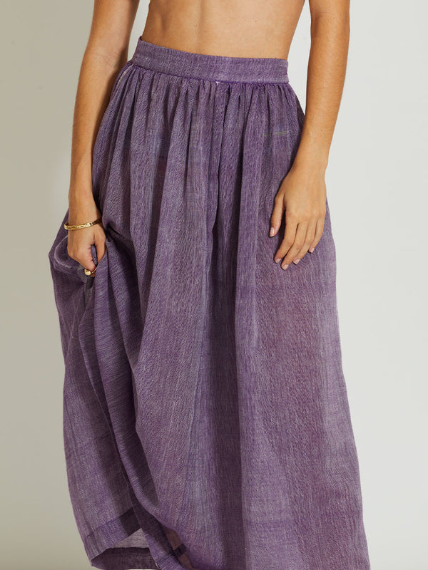 Close up on a Woman Standing Wearing lemlem FREYE | Skirt featuring sheer fabric in rich plum color