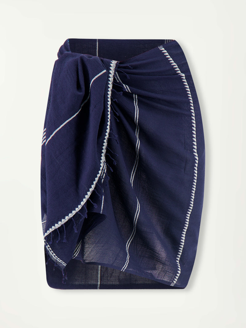 Product front shot of LEMLEM Sarong featuring white Tibeb bands on a rich navy silhouette