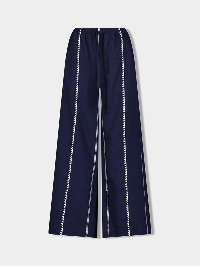 Product Front shot of lemlem DESTA handwoven pants featuring white tibeb pattern on navy background