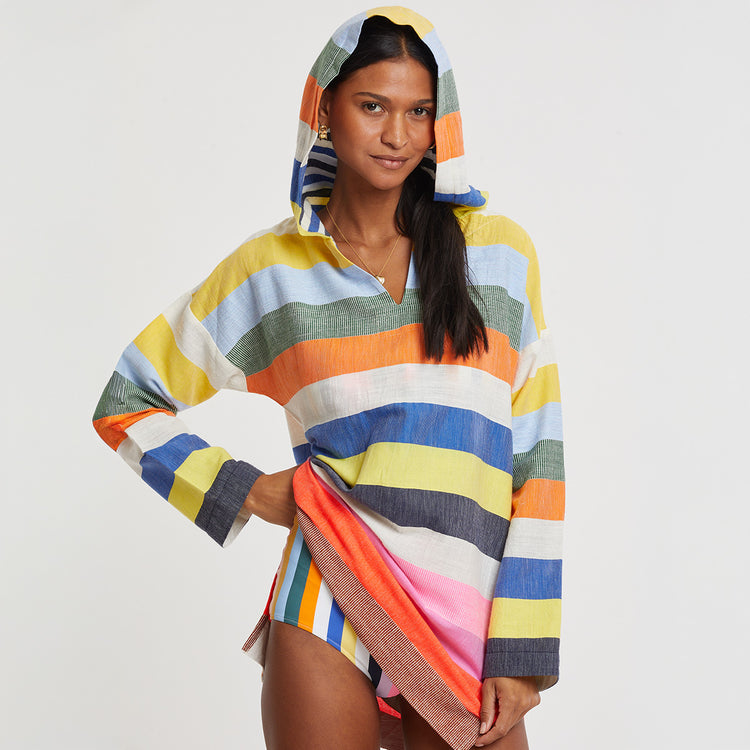 Woman standing wearing lemlem handwoven HENOK Hoodie featuring multicolor striped pattern 