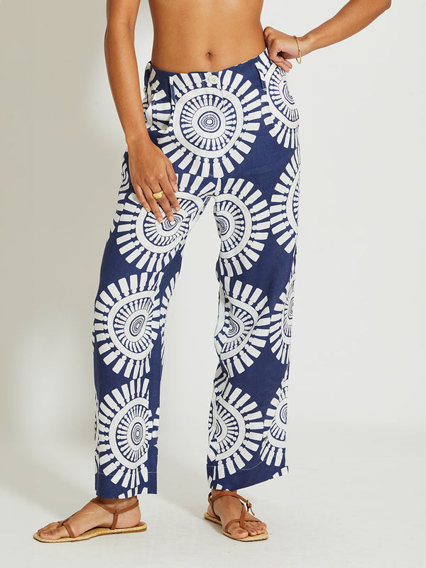 Close up on a Woman Standing Wearing lemlem DIARRA | Trousers Featuring a bold geometric medallion pattern on navy background, inspired by traditional Tibeb motifs.