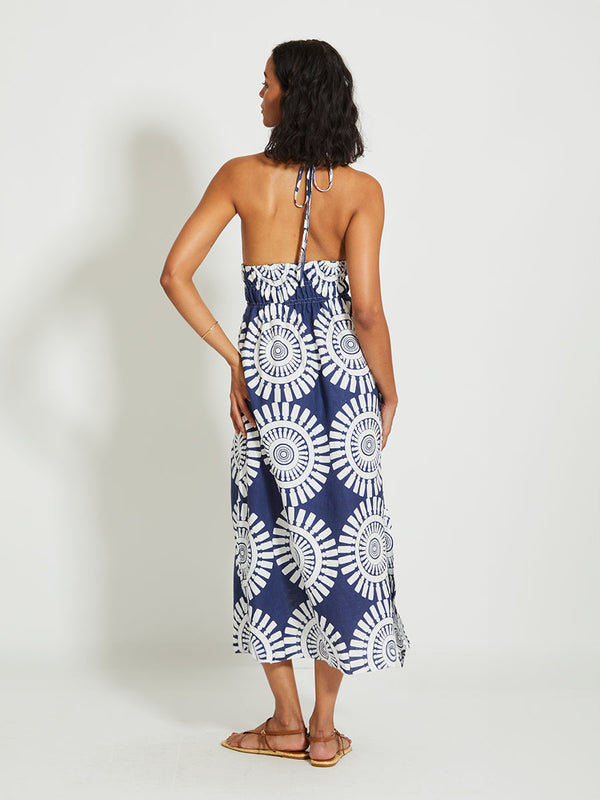 Back of a Woman Standing Wearing lemlem GETE | Triangle Dress Featuring a bold geometric medallion pattern on navy background, inspired by traditional Tibeb motifs.