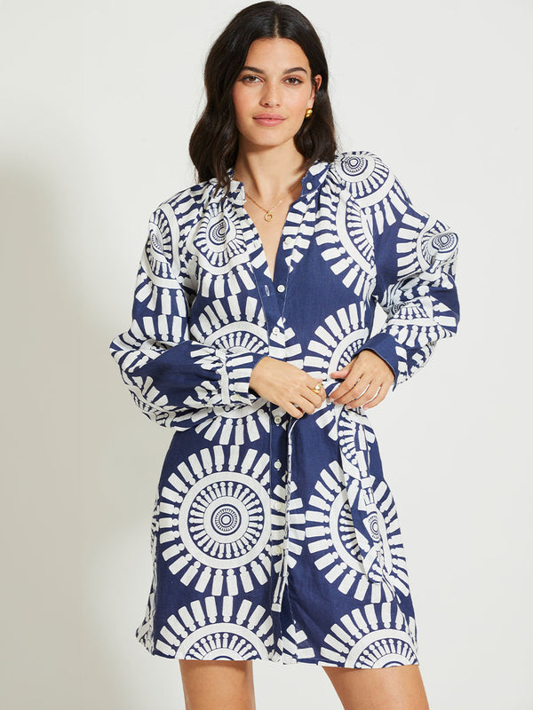 Woman Standing Wearing lemlem MEAZA | Button Up Dress Featuring a bold geometric medallion pattern on navy background, inspired by traditional Tibeb motifs.