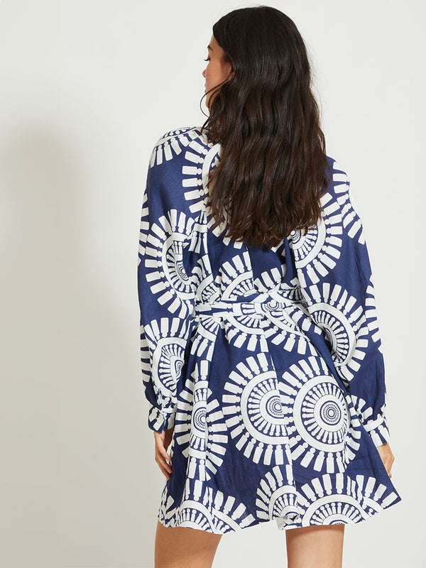 Back of a Woman Standing Wearing lemlem MEAZA | Button Up Dress Featuring a bold geometric medallion pattern on navy background, inspired by traditional Tibeb motifs.