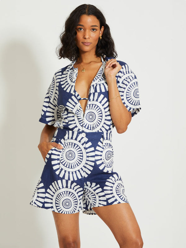 Woman Standing Wearing lemlem FAIZAH | Shorts Featuring a bold geometric medallion pattern on navy background, inspired by traditional Tibeb motifs.