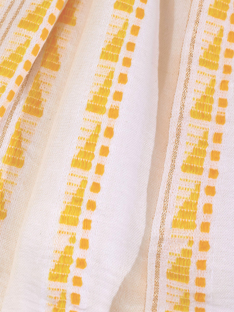 Close up on the fabric of the Abeba Tunic Dress featuring the yellow signature Tibeb pattern and gold lurex highlights on a white background.
