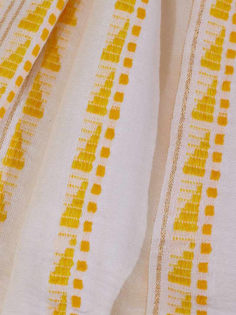 Close up on the fabric of the Abeba Classic Caftan featuring the yellow signature Tibeb pattern and gold lurex highlights on a white background.