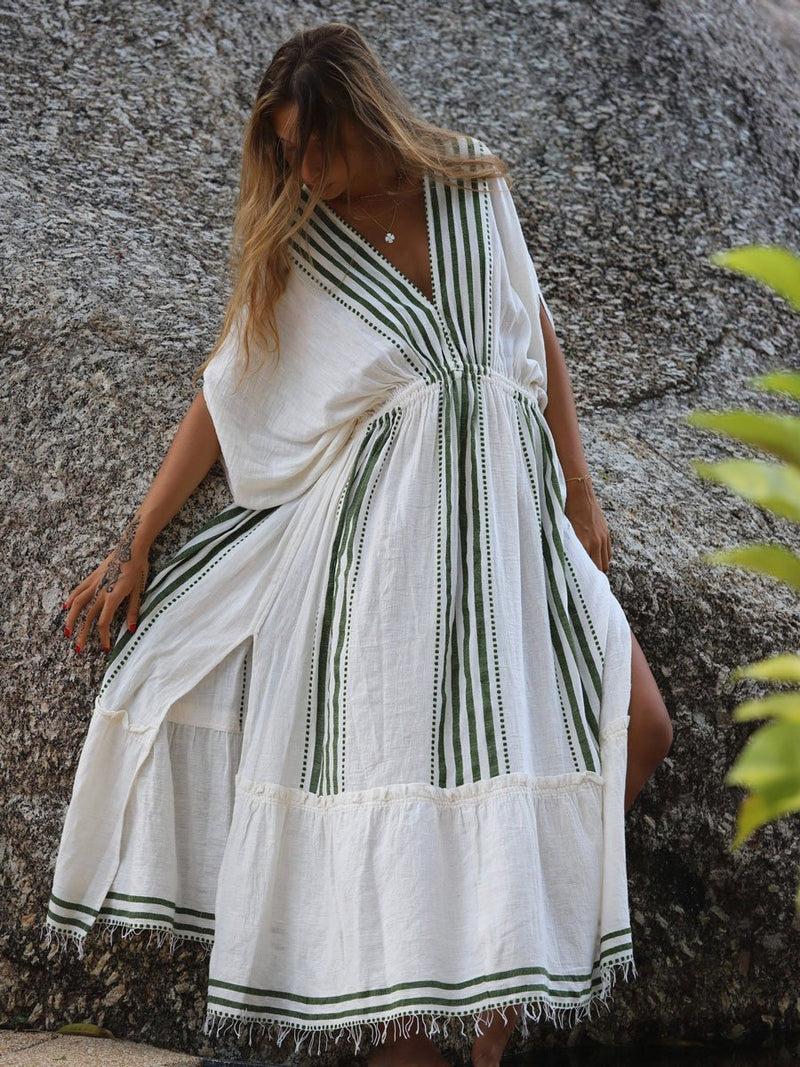 woman wearing white plunge neck dress with green stripes and dots