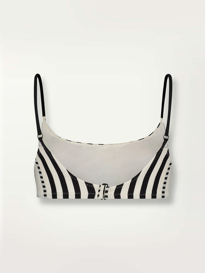 Product shot of the back the Eshe Bralette Top featuring architectural and textured black stripes and dotted lines on an off white background.