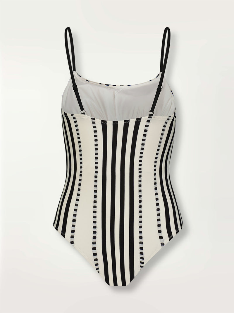 Product shot of the back the Eshe Classic One Piece featuring architectural and textured black stripes and dotted lines on an off white background.