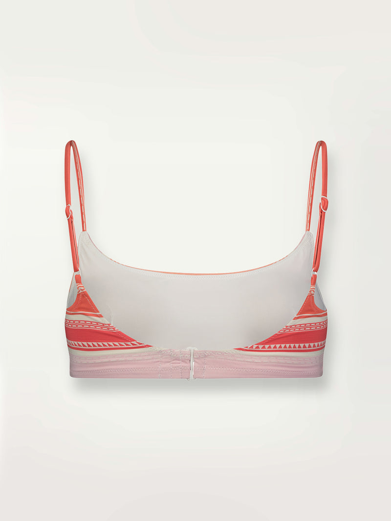 Product shot of the back the Eshal Bandeau Top featuring white doted stripes with gradiant orange and tangerine bands on a lilac and white background.