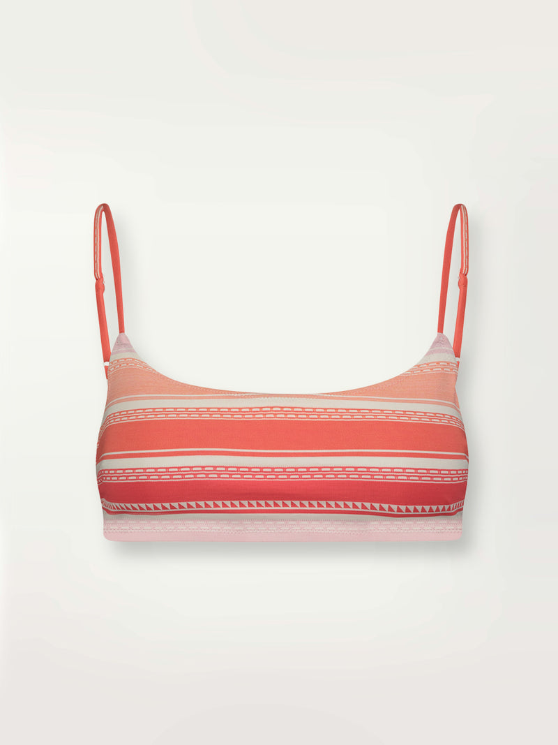 Product shot of the Eshal Bandeau Top featuring white doted stripes with gradiant orange and tangerine bands on a lilac and white background.