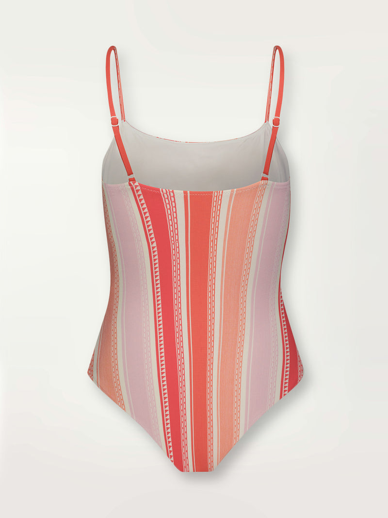 Product shot of the back the Eshal Classic One Piece featuring white doted stripes with gradiant orange and tangerine bands on a lilac and white background.