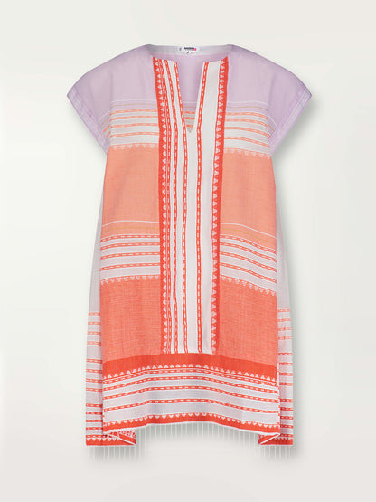 Product shot of the Eshal Caftan Dress featuring white doted stripes with gradiant orange and tangerine bands on a lilac and white background.