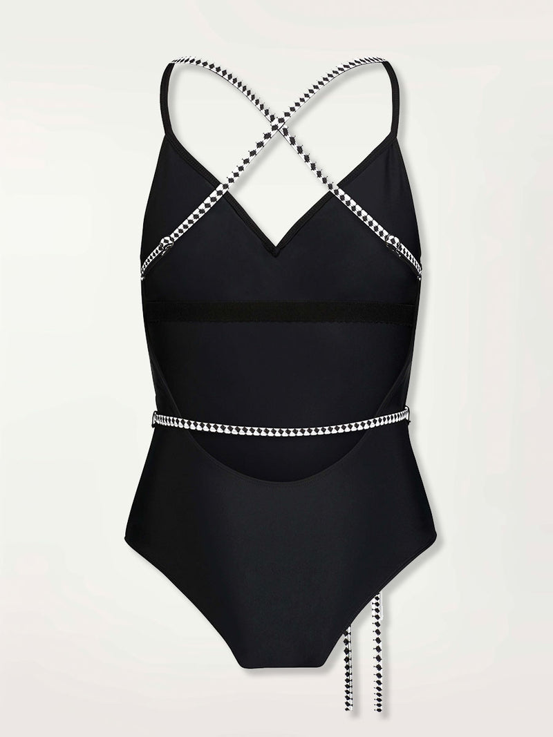 Product shot of the back of the Lena Ballet One Piece in Black featuring a black and white tibeb trim and waist tie.