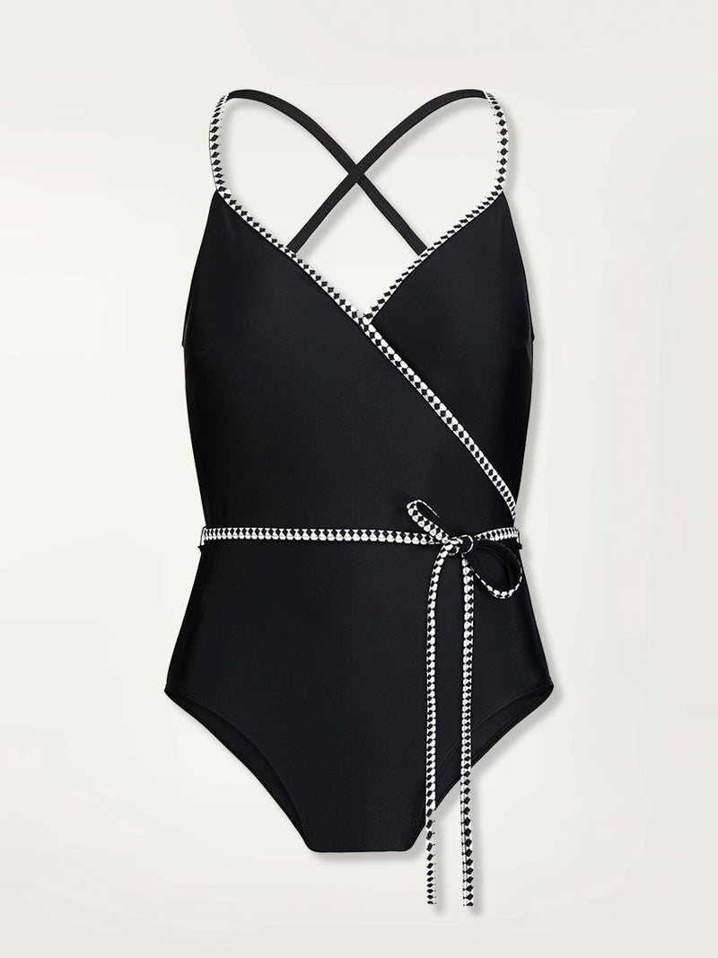 Product shot of the front of the Lena Ballet One Piece in Black featuring a black and white tibeb trim and waist tie.