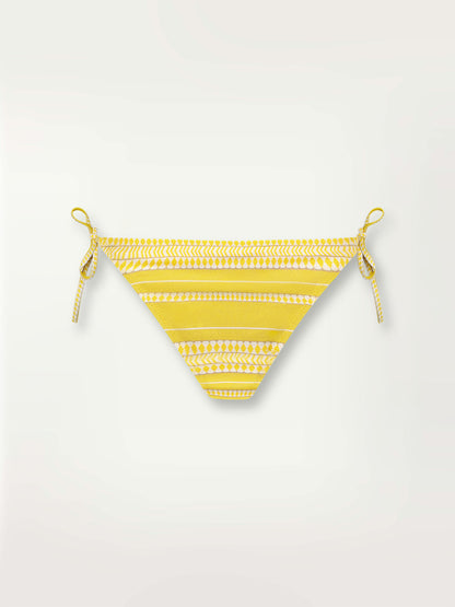 Product shot of the Luchia String Bikini Bottom in yellow and enhanced with ivory and strands of golden shimmering lurex.