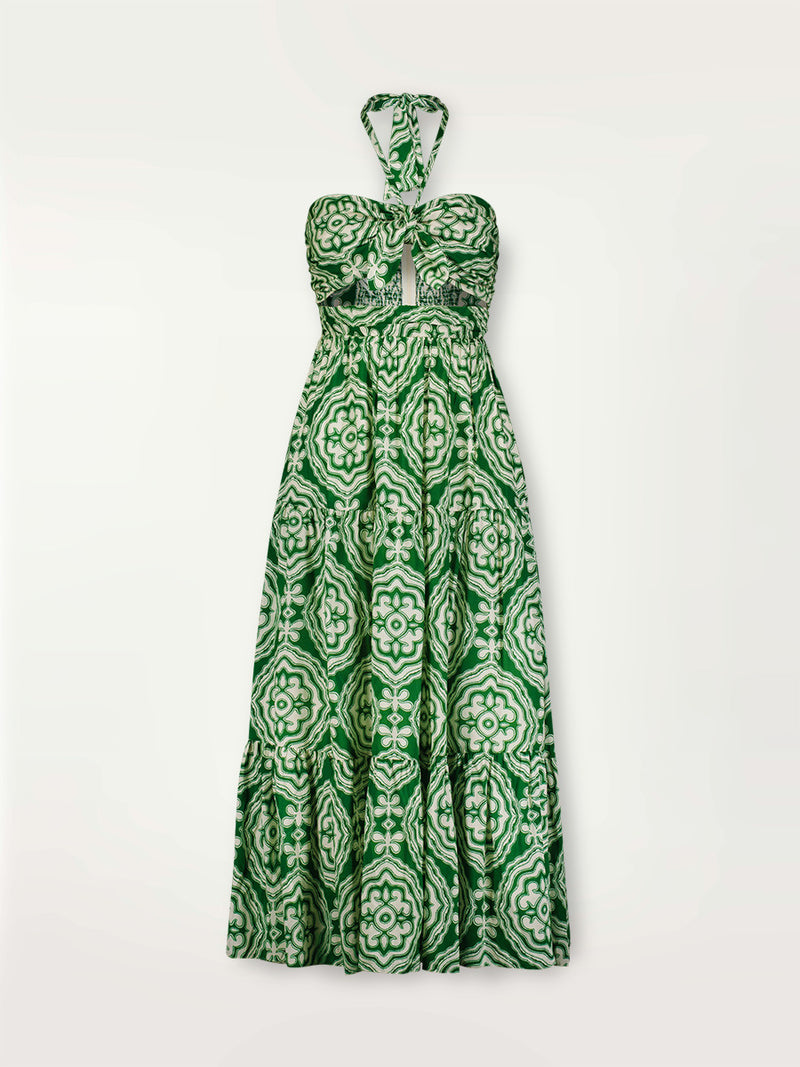 Product shot of the Medallion Cutout Dress featuring architectural white patterns on a deep green background.