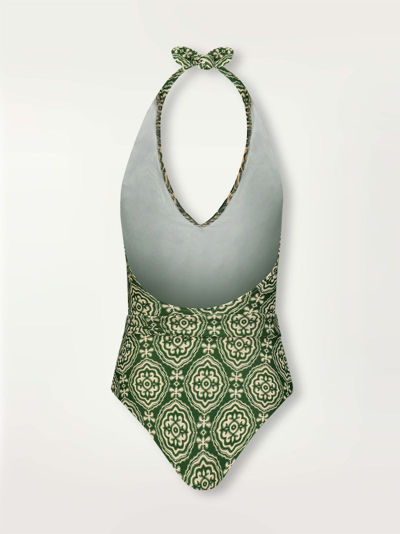 Product shot of the back the Medallion Deep V One Piece featuring architectural white patterns on a deep green background.