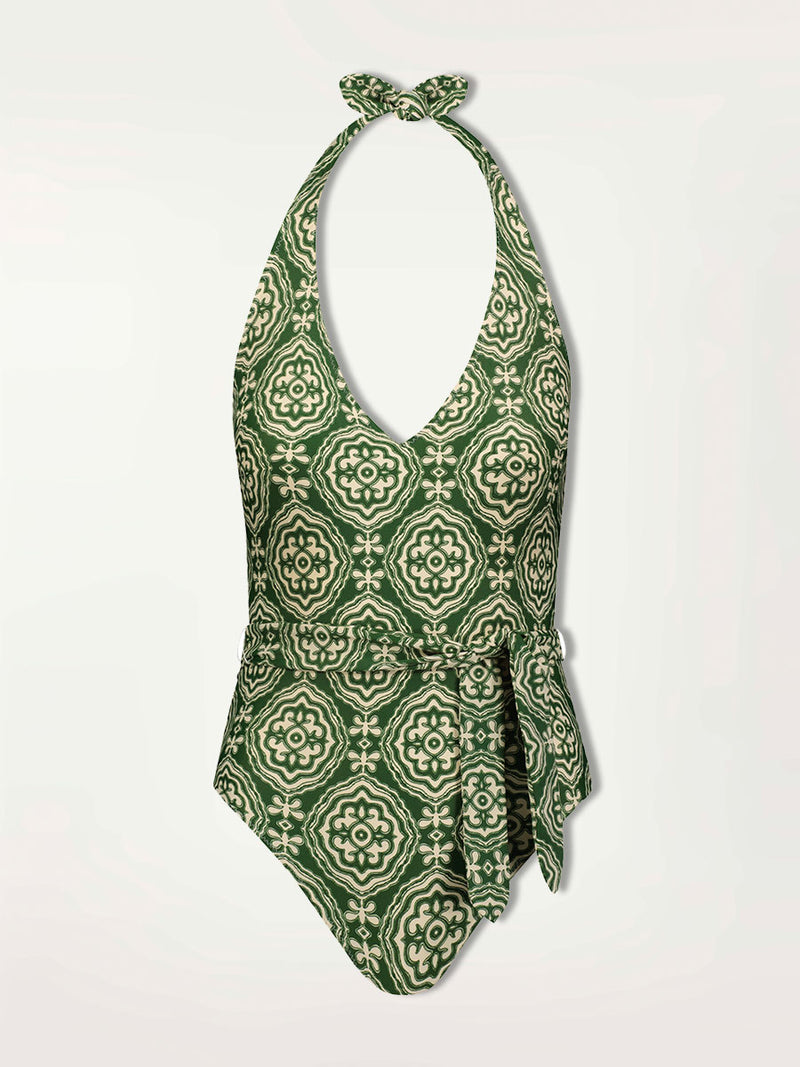 Product shot of the Medallion Deep V One Piece featuring architectural white patterns on a deep green background.