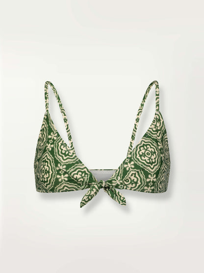 Product shot of the Medallion Tie Front Bikini Top featuring architectural white patterns on a deep green background.