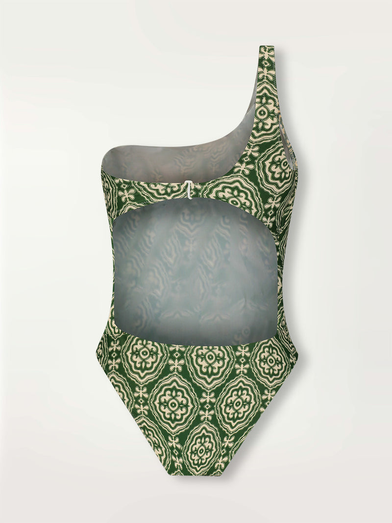 Product shot of the Medallion One Shoulder One Piece featuring architectural white patterns on a deep green background.