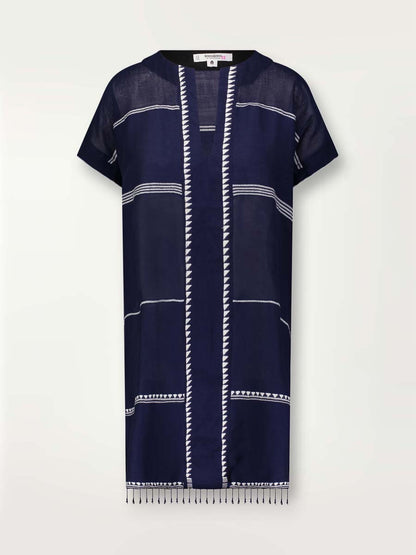 Product shot of the front of the Nunu Tunic Dress in navy blue featuring white stripes and graphic lines.