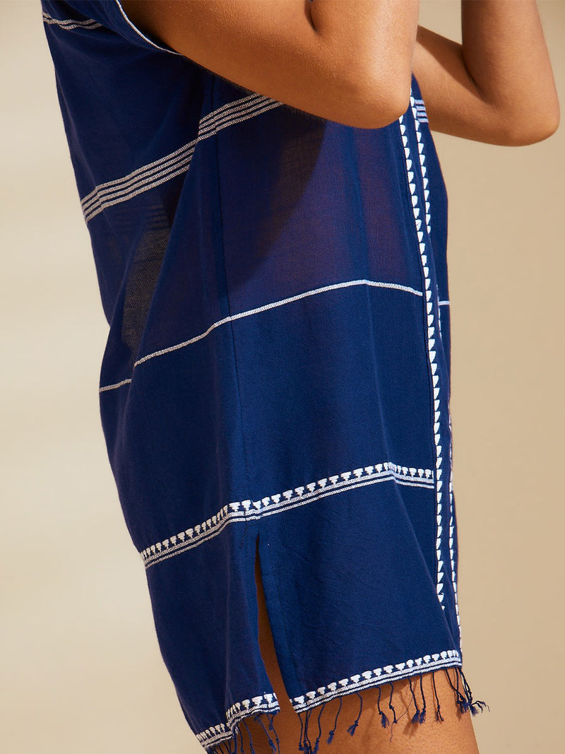 Close up on the legs of a woman wearing the Nunu Tunic Dress in navy blue featuring white stripes and graphic lines.