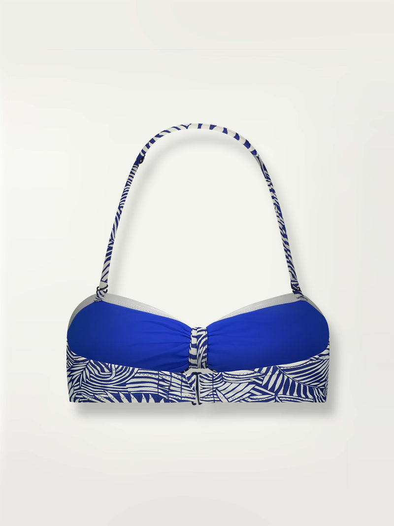 Product shot of the back the Palm Leaf Bandeau Top featuring palm tree patterns on a rich blue background.