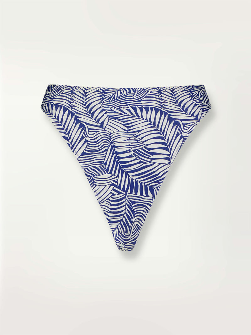 Product shot of the Palm Leaf High Leg Bikini Bottom featuring palm tree patterns on a rich blue background.