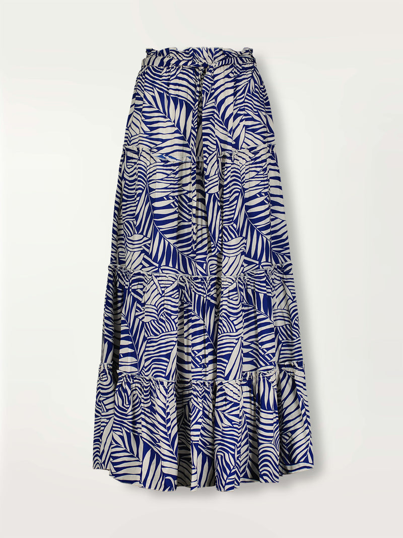 Product shot of the Palm Leaf Maxi Skirt featuring palm tree patterns on a rich blue background.